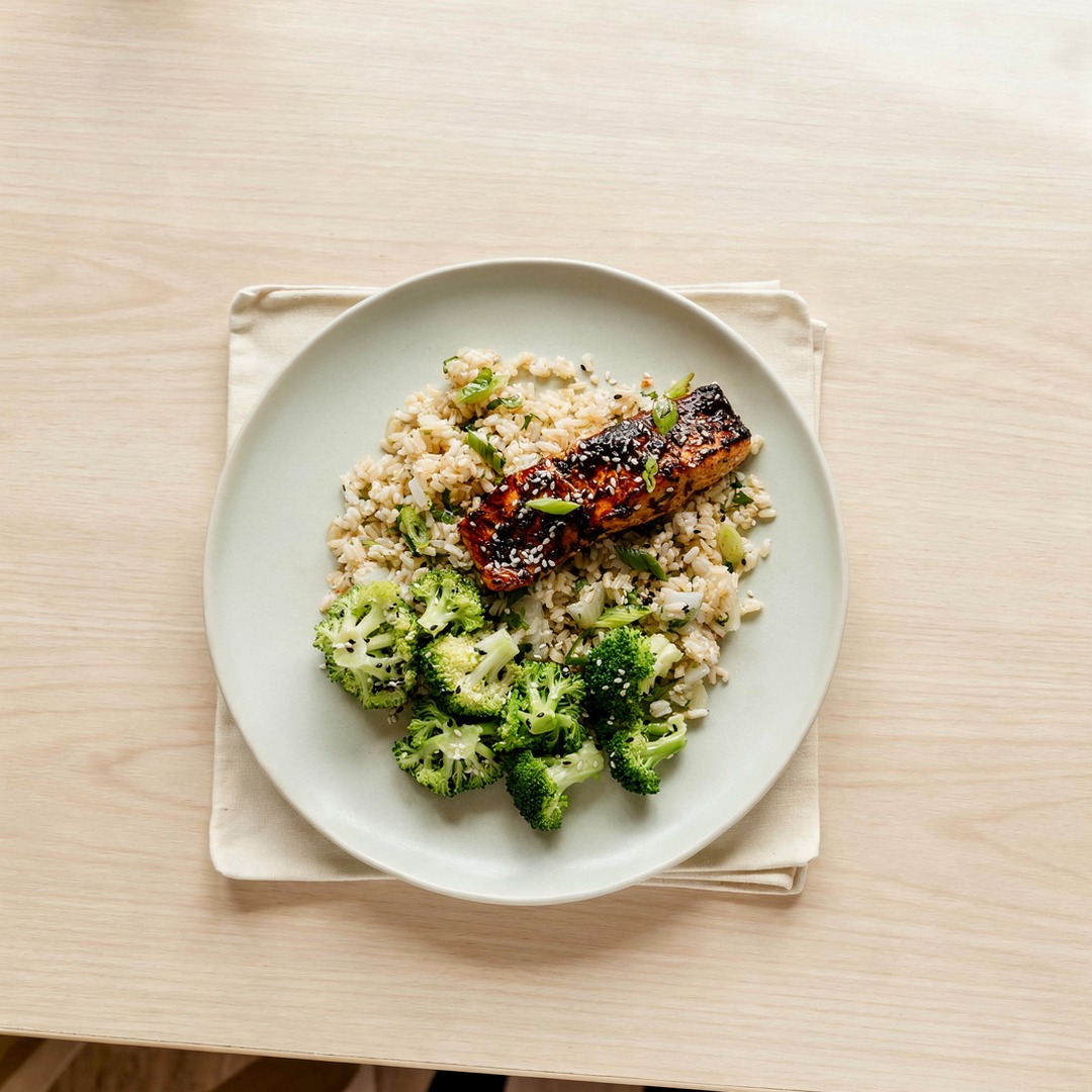 Overhead plate of a Territory dinner with salmon and vegetables on a cream table